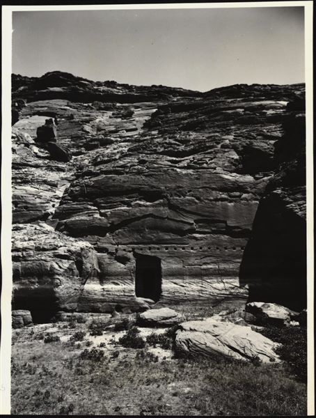 Photograph of the rock-cut chapel of Ellesiya in its original location in Nubia, shortly before the Nile waters would begin to rise due to the construction of the Aswan Dam, which would flood the area. Photograph taken in the mid-1960s, shortly before the rock-cut chapel was moved.