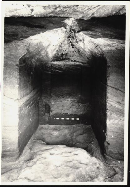 Photograph of the back niche in the rock-cut chapel of Ellesiya, where the statues of deities and the pharaoh (Horus of Miam, Tuthmosis III and Satet) were located. The rock-cut chapel is in its original location in Nubia, shortly before the Nile waters would begin to rise due to the construction of the Aswan Dam, which would flood the area. Photograph taken in the mid-1960s, shortly before the rock-cut chapel was moved. Note the original floor, which was not saved.