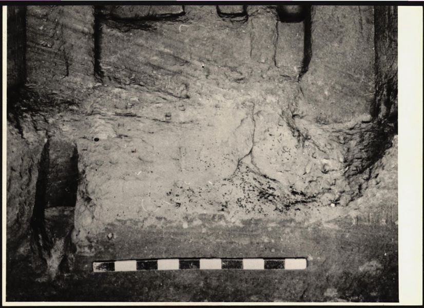 Photograph of the back niche in the rock-cut chapel of Ellesiya, where the statues (just visible) of deities and the pharaoh were located. The rock-cut chapel is still in its original location in Nubia, shortly before the Nile waters would begin to rise due to the construction of the Aswan Dam, which would flood the area. Photograph taken in the mid-1960s, shortly before the rock-cut chapel was moved. Note the original floor, which was not saved.