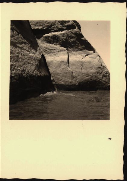 Photograph of the side facade wall from the rock-cut chapel of Ellesiya, showing the rising waters of Lake Nasser, which in a short time would have submerged the entire rock-cut chapel. Photograph taken from a boat.