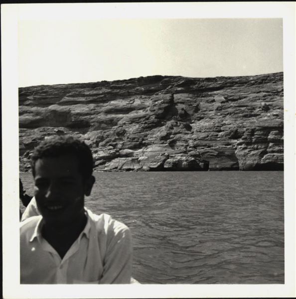 Photograph taken in the direction of the rock-cut rock-cut chapel of Ellesiya that can be seen in the background. In a short time, the rock-cut chapel would have been submerged by Lake Nasser, which had already formed and was full. Photograph taken from a boat.