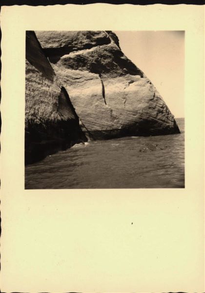 Photograph of the side facade wall from the rock-cut chapel of Ellesiya, showing the rising waters of Lake Nasser, which in a short time would have submerged the entire rock-cut chapel. Photograph taken from a boat.