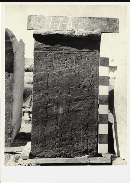 Storage at Wadi es-Sebua, one of the 66 blocks from the rock-cut chapel of Ellesiya stored waiting to be transported to Turin, after the United Arab Republic decided to gift the rock-cut chapel to the Italian Republic. Wall scene to the left of the transverse hall’s entrance, where Pharaoh Tuthmosis III, wearing the Atef crown, is shown between the goddess Anuket (left) and the goddess Satet (right); goddesses of the cataract at Aswan. 