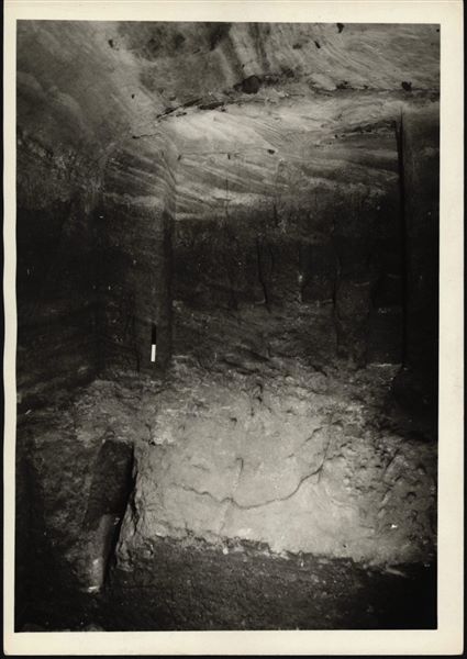 Photograph of the back niche in the rock-cut chapel of Ellesiya, where the statues (just visible) of deities and the pharaoh were located. The rock-cut chapel is still in its original location in Nubia, shortly before the Nile waters would begin to rise due to the construction of the Aswan Dam, which would flood the area. Photograph taken in the mid-1960s, shortly before the rock-cut chapel was moved. Note the original floor, which was not saved.
