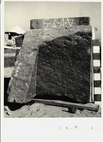 Storage at Wadi es-Sebua, one of the 66 blocks from the rock-cut chapel of Ellesiya stored waiting to be transported to Turin, after the United Arab Republic decided to gift the rock-cut chapel to the Italian Republic. Back left wall of the transverse hall, forming a corner with the left wall of the same room, depicting the goddess Isis-Serket as she embraces the Pharaoh Tuthmosis III. On the right is the Pharaoh again, in a scene connected with the god Amun-Ra, who isn’t visible on this block. 