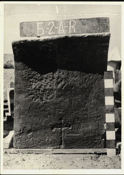 Storage at Wadi es-Sebua, one of the 66 blocks from the rock-cut chapel of Ellesiya stored waiting to be transported to Turin, after the United Arab Republic decided to gift the rock-cut chapel to the Italian Republic. Wall scene from the left side of the chapel, with Tuthmosis III offering incense to Amun-Ra, seated on a throne. 