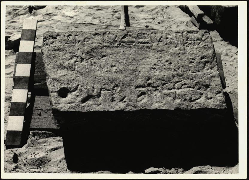 Storage at Wadi es-Sebua, one of the 66 blocks from the rock-cut chapel of Ellesiya stored waiting to be transported to Turin, after the United Arab Republic decided to gift the rock-cut chapel to the Italian Republic. One of the blocks forming part of the right side of the recess, on the rock-cut chapel's exterior façade.