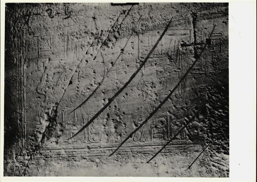 Photograph of an interior section from the rock-cut chapel of Ellesiya, shortly before it was moved. Photograph taken in the mid-1960s. Depicted on the left wall of the chamber, from the left: Amun-Re seated, Tuthmosis III and the goddess Satet, also seated.