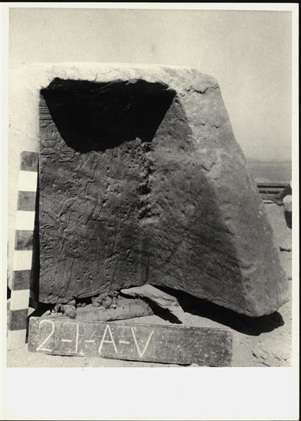 Storage at Wadi es-Sebua, one of the 66 blocks from the rock-cut chapel of Ellesiya stored waiting to be transported to Turin, after the United Arab Republic decided to gift the rock-cut chapel to the Italian Republic. Scene from the back right wall of the transverse hall, showing Tuthmosis III near a pile of offerings, which is in front of the subject depicted in photo C2_9_130.