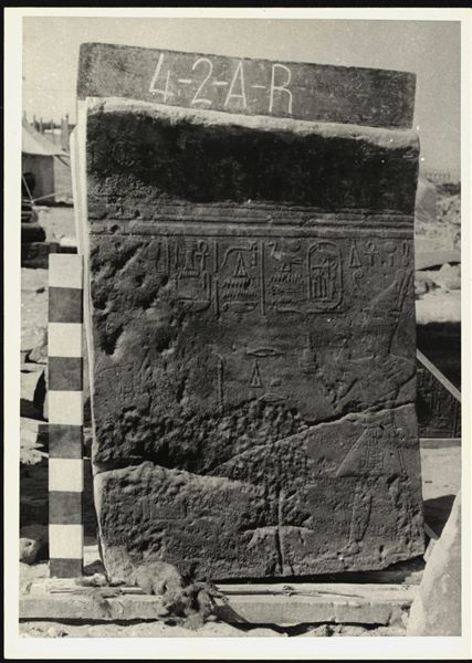 Storage at Wadi es-Sebua, one of the 66 blocks from the rock-cut chapel of Ellesiya stored waiting to be transported to Turin, after the United Arab Republic decided to gift the rock-cut chapel to the Italian Republic. Right wall from the chapel, pharaoh Tuthmosis III is visible on the right, offering milk to Horus of Miam, who is barely visible due to the poor condition of the block.