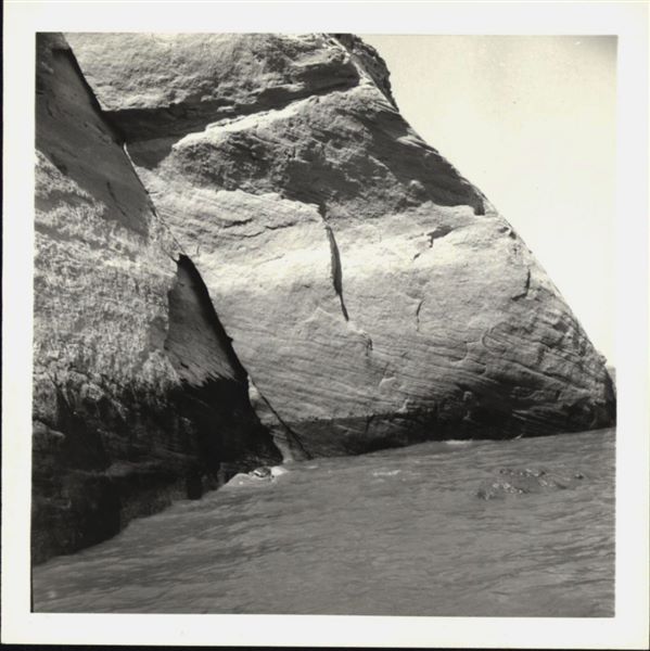 Photograph of the side facade wall from the rock-cut chapel of Ellesiya, documenting the rising waters of Lake Nasser, which in a short time would have submerged the entire rock-cut chapel. Photograph taken from a boat.
