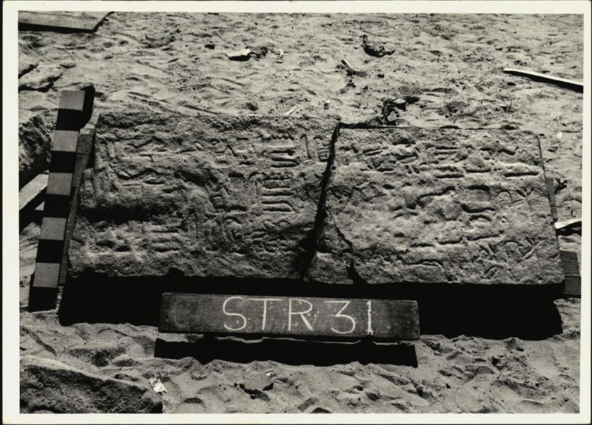 Storage at Wadi es-Sebua, one of the 66 blocks from the rock-cut chapel of Ellesiya stored waiting to be transported to Turin, after the United Arab Republic decided to gift the rock-cut chapel to the Italian Republic. One of the blocks forming part of the right side of the recess, on the rock-cut chapel's exterior façade.