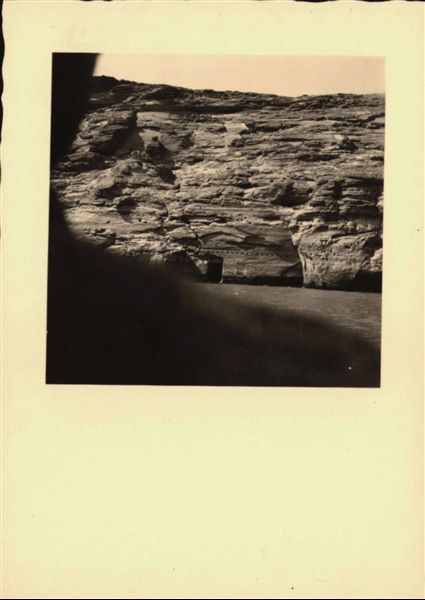 Photograph taken in the direction of the rock-cut Temple of Ellesiya that can be seen in the background. In a short time, the temple would have been submerged by the growing Lake Nasser, which had already formed and was quite large. Photograph taken from a boat.