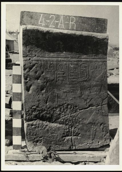 Storage at Wadi es-Sebua, one of the 66 blocks from the Temple of Ellesiya stored waiting to be transported to Turin, after the United Arab Republic decided to gift the temple to the Italian Republic. Right wall from the chapel, pharaoh Thutmosis III is visible on the right, offering milk to Horus of Miam, who is barely visible due to the poor condition of the block.