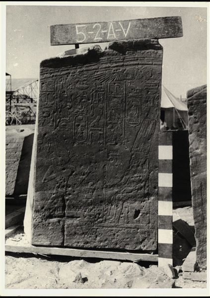 Storage at Wadi es-Sebua, one of the 66 blocks from the Temple of Ellesiya stored waiting to be transported to Turin, after the United Arab Republic decided to gift the temple to the Italian Republic. This scene is located on the left wall of the transverse hall and depicts Thutmosis III standing before of Amun-Ra. A Christian cross is clearly visible. 