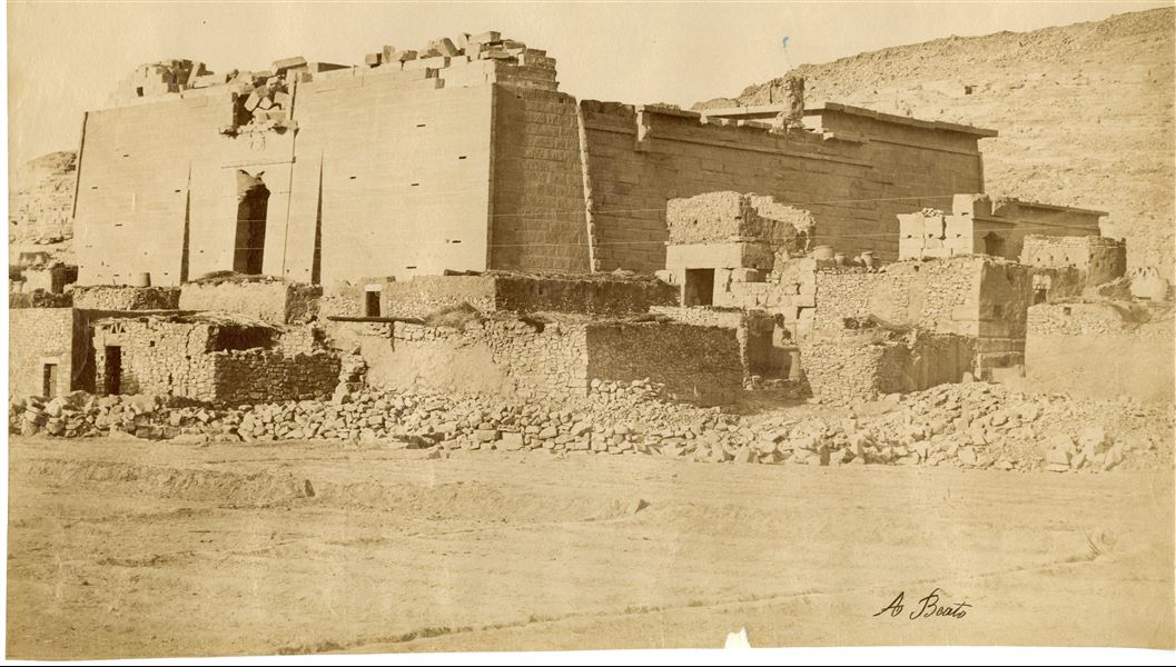 View of the Temple of Kalabsha built in honour of the god Mandulis, in its original position, and not yet restored. The top of the entrance pylon is in fact not fully stabilised. The temple was moved following the construction of the Aswan Dam and the resulting formation of Lake Nasser, which would have submerged it. The temple was then re-erected in the late 1960s at New Kalabsha, a location on higher ground not far from Aswan. The author's signature is visible at the bottom right. 