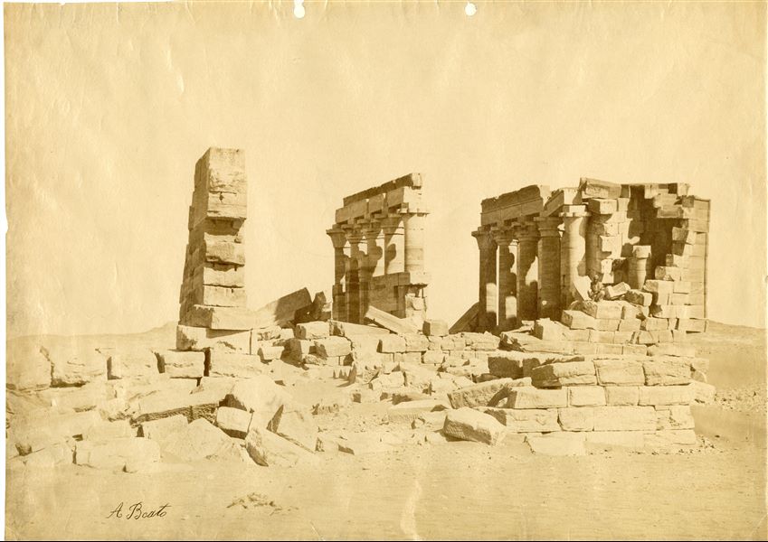 The image shows the ruins of the Nubian temple of Maharraqa, still in its original location, with a local sitting on some temple blocks. The author's signature is at the bottom left.