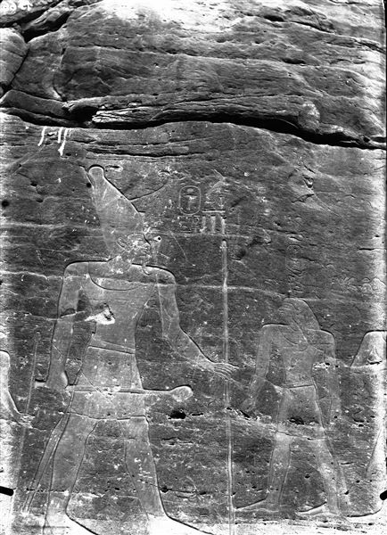 Inscription and rock-carved representation of Montuhotep II. On his right are his father Intef III, and the treasurer Khety, and on his left Queen Iah, the mother of Montuhotep II. 