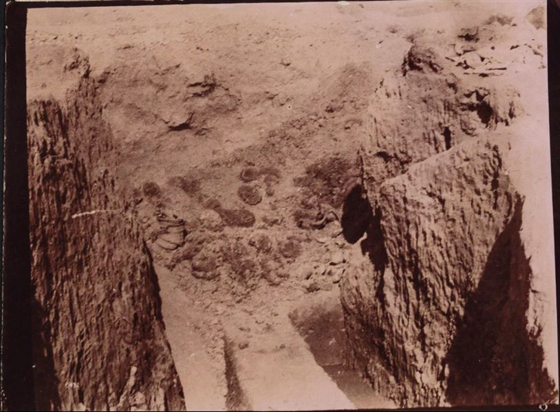 Excavating inside a trench, with some ancient materials surfacing from the earth. Schiaparelli excavations.
