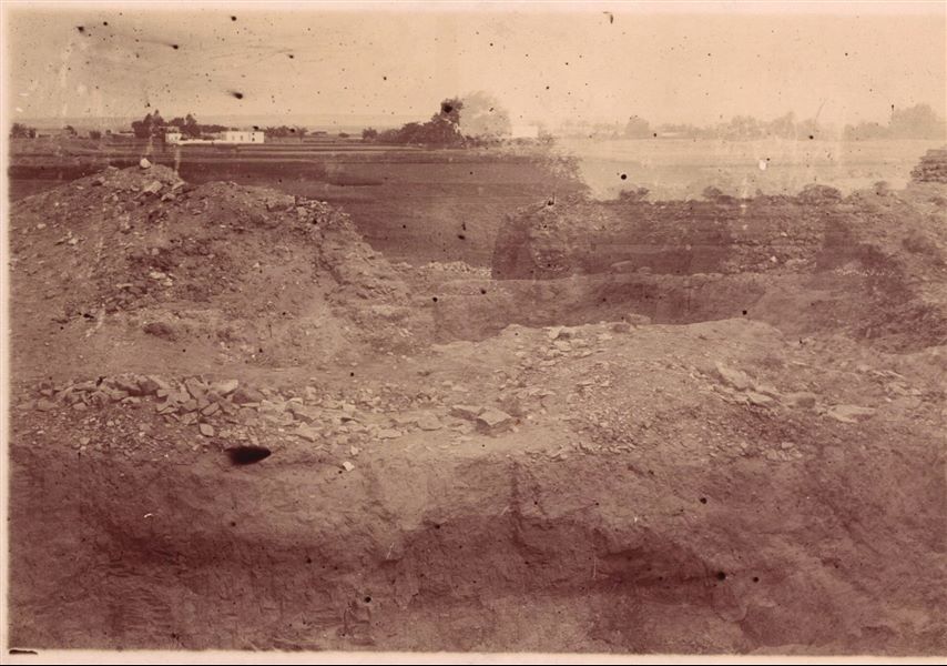 Excavating in one of the areas of the archaeological site of Heliopolis. The print shows an overexposure with another photograph, presumably of the same site. Schiaparelli excavations.