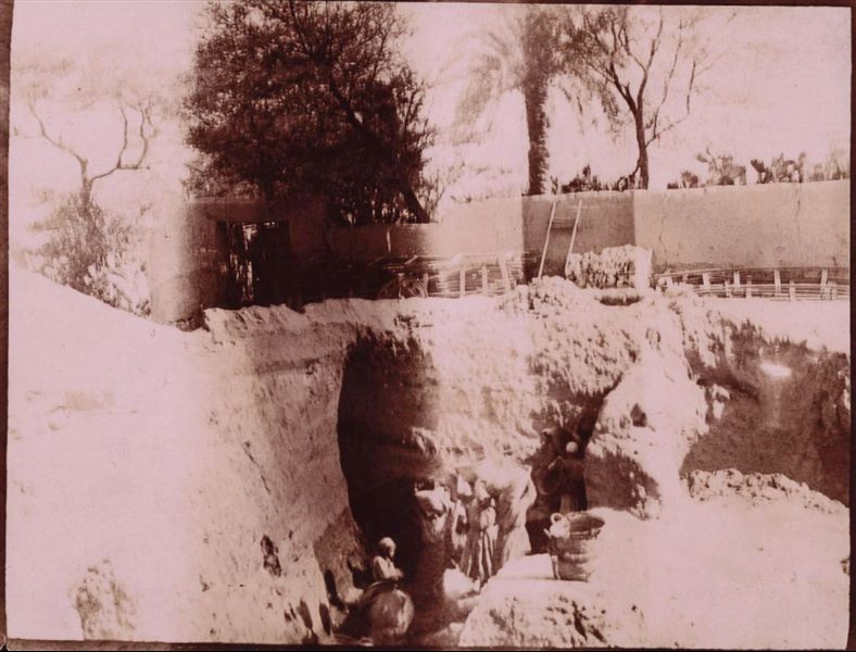 Excavation trench in the area of the Sun Temple. The wall of Latif's house is in the background. Photograph overexposed and in sepia. Schiaparelli excavations.