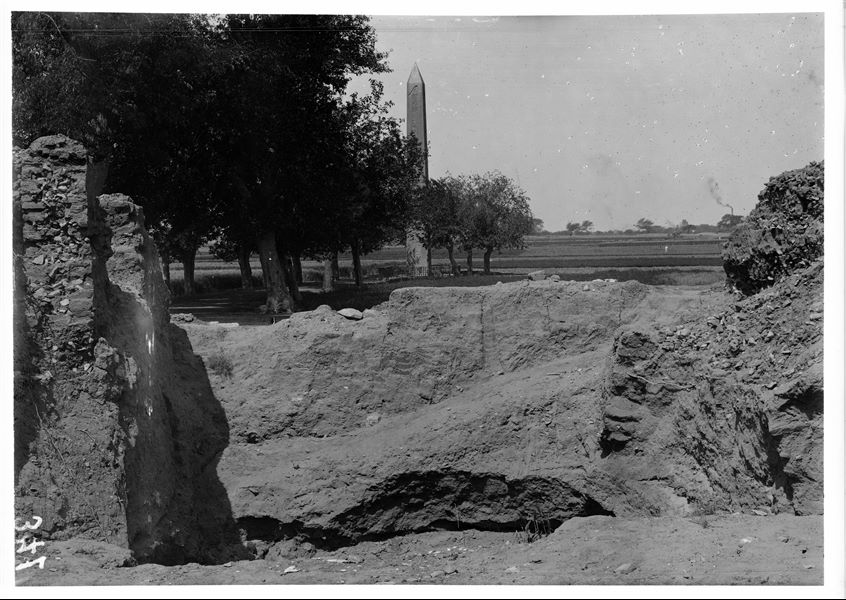 Area del Santuario del Sole, prima dello scavo; sono visibili ai lati i resti di case arabe (da est); sullo sfondo, il lato est dell’obelisco di Sesostri I e la strada che porta all’obelisco. Scavi Schiaparelli.