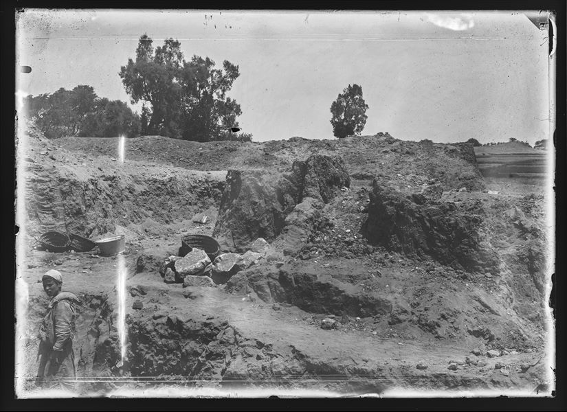 Break from the excavations at Heliopolis. In the lower left there is an Egyptian child near empty work baskets, probably a worker for the Mission. Schiaparelli excavations.
