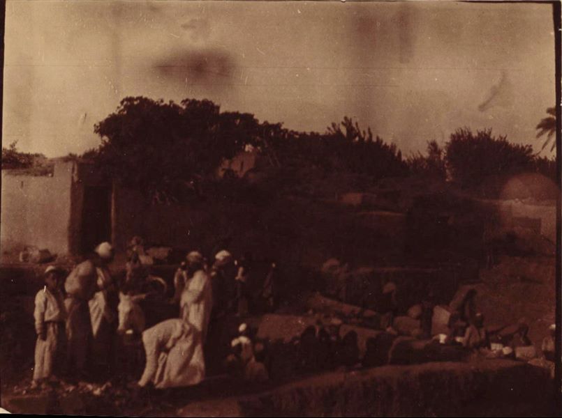 Photograph of excavations near a dwelling, unfortunately not identifiable. The photo is dark and not very clear.