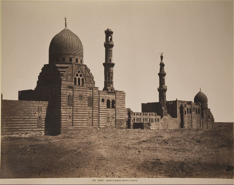 Photograph of a mausoleum-mosque in the Islamic cemetery in Cairo. According to the photo's original caption, it is said to be the mausoleum-mosque of Abd al-Malik ibn Marwan ibn al-Hakam (5th Caliph, who lived during the 8th century AD), however there is no evidence of this attribution today.  