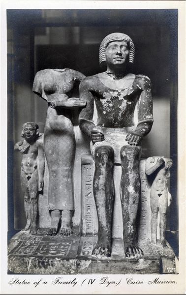 Gallery in the Egyptian Museum in Cairo. Group statue of a family, from the Old Kingdom. Album “Cartes postales” (Postcards).