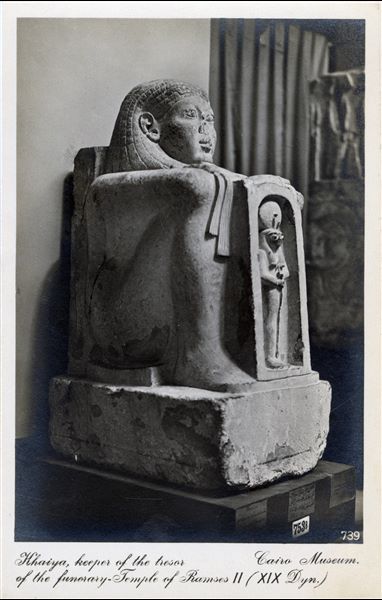 Gallery in the Egyptian Museum in Cairo. Statue of Khaiya with a shrine, treasurer of the Mortuary Temple of Ramesses II - the Ramesseum. Album “Cartes postales” (Postcards).