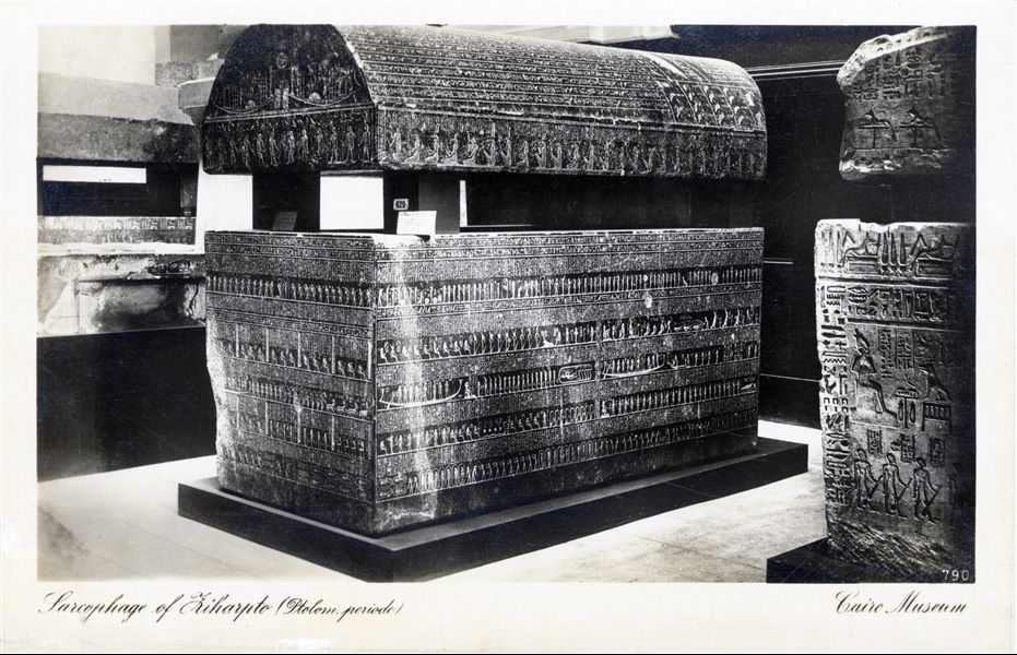 Gallery in the Egyptian Museum in Cairo. Granite sarcophagus of Tiharptoh, scribe and priest of the god Min. Ptolemaic Period. Album “Cartes postales” (Postcards).