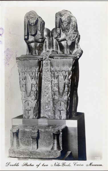 Gallery in the Egyptian Museum in Cairo. Double statue depicting Pharaoh Amenemhat III, one of the last rulers of the 12th dynasty, dressed as a Nilotic deity (Cairo JE 18221). Album “Cartes postales” (Postcards).