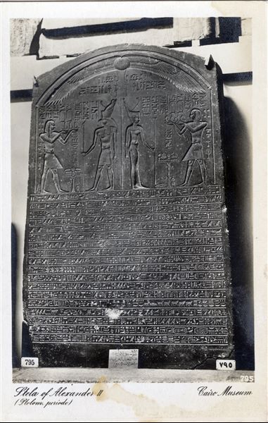 Gallery in the Egyptian Museum in Cairo. "The Satrap Stela", in black granite from the reign of Alexander IV. Ruling Egypt at the time however, was Ptolemy I Soter, who proclaimed himself pharaoh shortly afterwards, thus ushering in the Ptolemaic Period (Cairo CG 22182). Statue found whilst excavating a small chamber in the mosque of Amir Shaykhu, Cairo, in 1870. Album “Cartes postales” (Postcards).