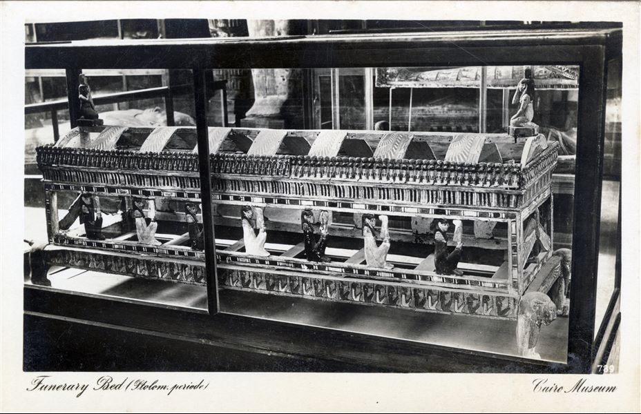 Gallery in the Egyptian Museum in Cairo. Particularly elaborate wooden funerary bed. Album “Cartes postales” (Postcards).