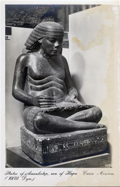 Gallery in the Egyptian Museum in Cairo. Statue of Amenhotep, son of Hapu. 18th dynasty. Album “Cartes postales” (Postcards). 