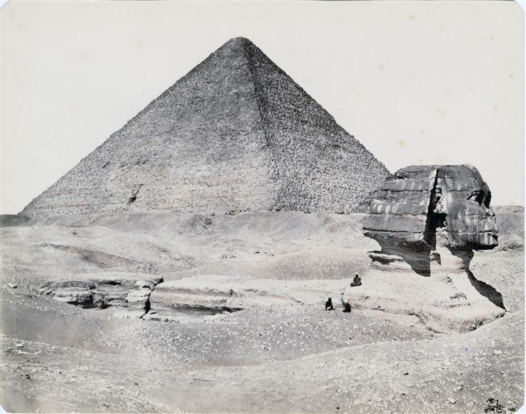 The photograph shows a partial view of the Giza Plateau, with the profile of the Sphinx (still to be cleared of sand) and the pyramid of Pharaoh Khufu.