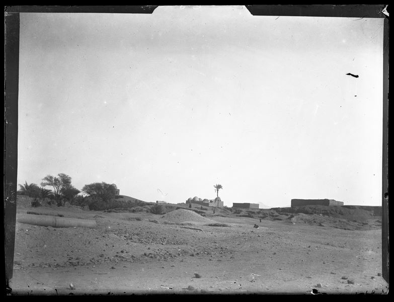  Landscape around the Italian Archaeological Mission’s camp at Ashmunein, where a column on the ground can be seen on the left. Some buildings of the modern village are visible on the horizon. Schiaparelli excavations.