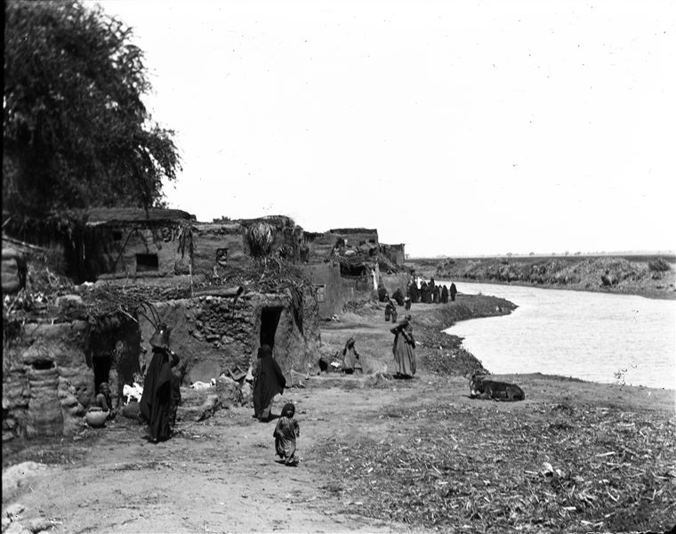 Area near the excavations, part of the modern village can be seen, on the right there is a canal. Schiaparelli excavations.