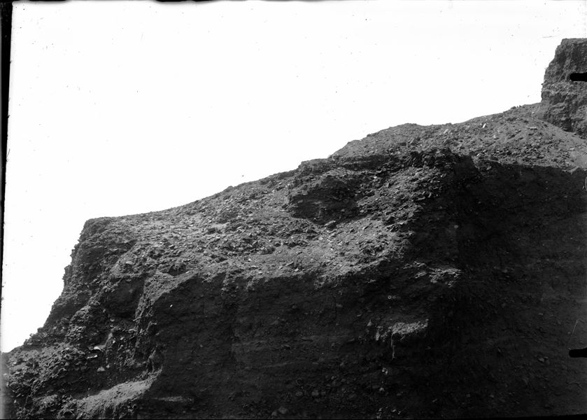 Panoramic photograph composed of four pictures. In this first image (1/4) it is visible an abundance of clay fragments, with several layers forming a mound of debris. Schiaparelli excavations.