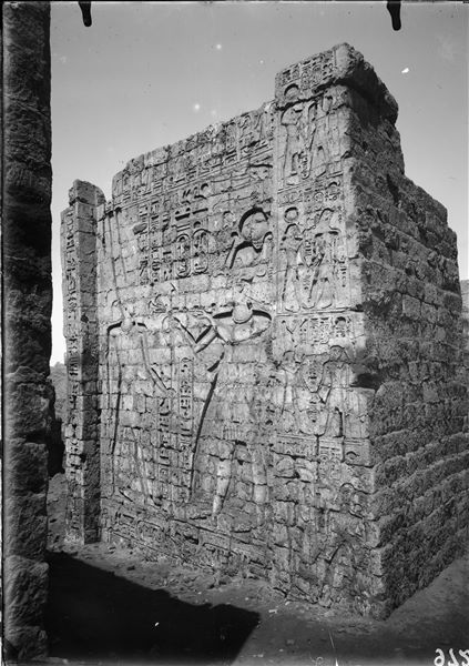 Right side of the entrance portal of the temple of Amun (and Thoth) inside the sacred enclosure of the temple of Thoth. On the left, the god Amun, on the right, pharaoh Seti II. Photograph taken from outside the temple. Schiaparelli excavations.