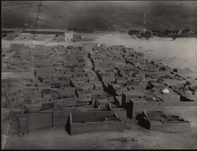 Partial view of the village of Asyut. In the background, the church of the Franciscan Mission. Schiaparelli excavations.