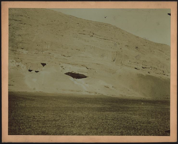 View of the cave in the mountain of Qau, photographed from the plain, used as a camp for the Italian Archaeological Mission. In the centre, the flagpole is visible, while to the left; one of the mission's conical tents can be seen. Schiaparelli excavations.