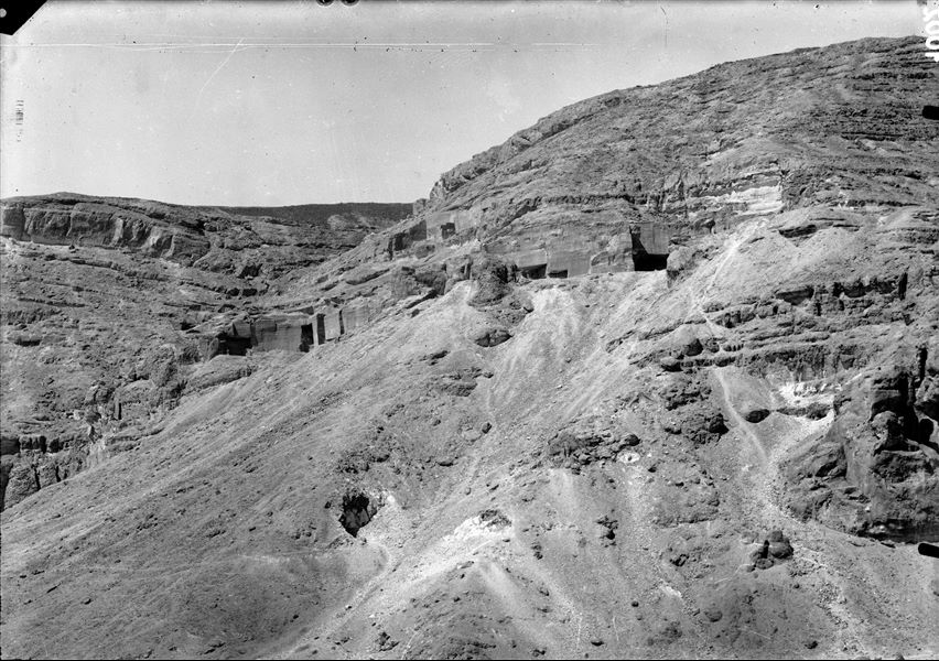 Qau el-Kebir, general view of the area presumably towards the east, the caves being used as quarries are visible here. Schiaparelli excavations.  