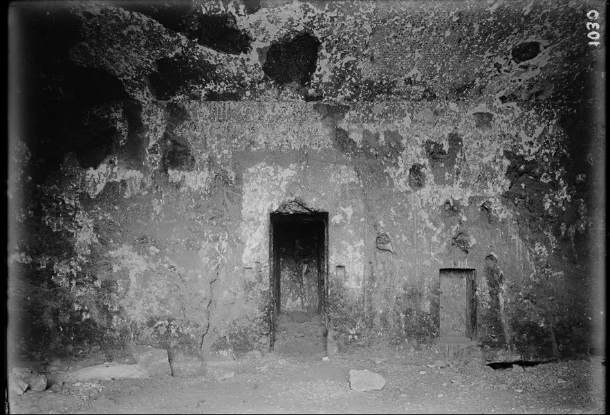 Tomb of Wahka II, first underground chamber, back wall, in the centre the final wall of the next room is visible. The wall decorations are fragmentary. Schiaparelli excavations.