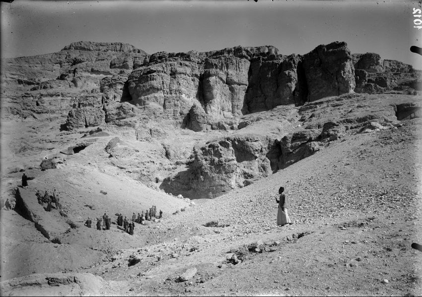 A small valley situated between the tomb of Wahka I to the west (left) and the tomb of Ibu to the east (right). The guide and interpreter Bolos Ghattas is visible at the centre. Photograph probably taken at the beginning of the excavation. Schiaparelli excavations.