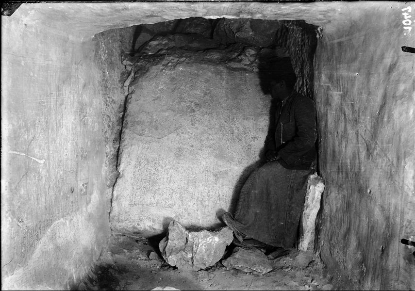 Wall inscriptions, back wall of Henib's burial chamber, in a corridor yet to be identified. Bolos Ghattas is leaning against the back wall. Schiaparelli excavations.  