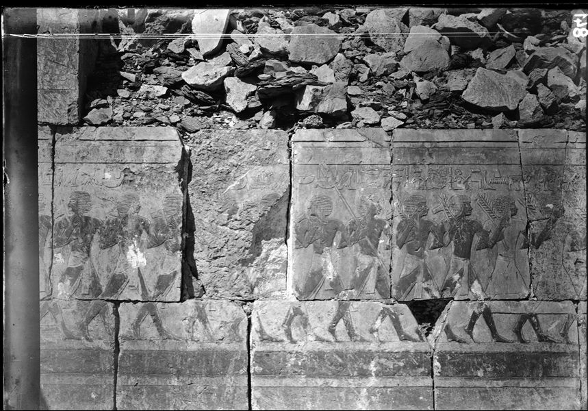 South side of the mortuary temple of Queen Hatshepsut at Deir el-Bahari, lower colonnade wall. It is visible a military parade. Photograph taken before restoration of the wall. 