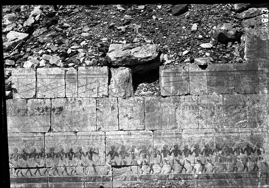 South side of the mortuary temple of Queen Hatshepsut at Deir el-Bahari, lower colonnade wall. In the upper register, the transport of obelisks and in the lower, a military parade. Photograph taken before restoration of the wall. 